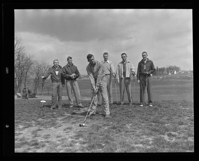6 golfers with clubs golf team