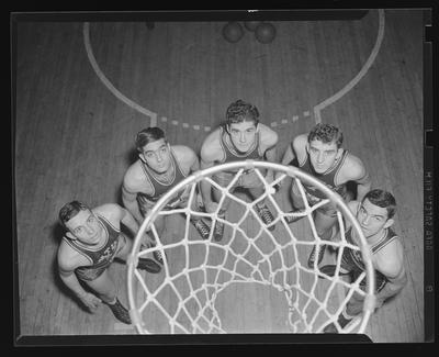 Group of players under basketball goal