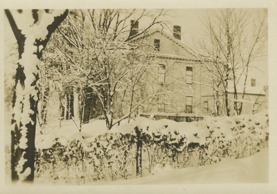 a snow scene, with a building in the background