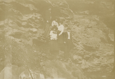 2 men and 3 women standing on a rock formation