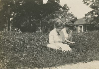 2 women sitting in the grass