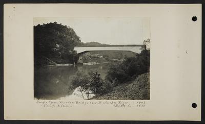 Covered bridge over river, few houses and buildings surrounding it, notation                          Single span wooden bridge over Kentucky River 1908, built in 1838, Camp Nelson