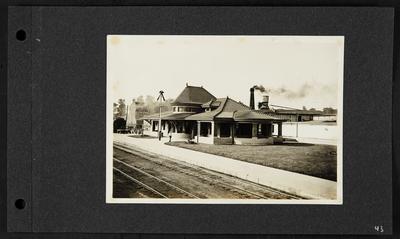 Danville train station, chimney reading                          Planning Mill, man and small child standing on sidewalk, hose on grass, building in back readings                          Royal Blue