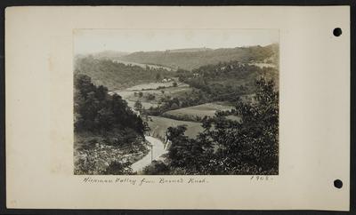 View from above of crops in valley, road going around bend in foreground, few buildings in distance, notation                          Hickman Valley from Boone's Knob 1908