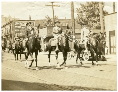 Three mounted men in a Memorial Day Parade, handwritten in ink on back: 