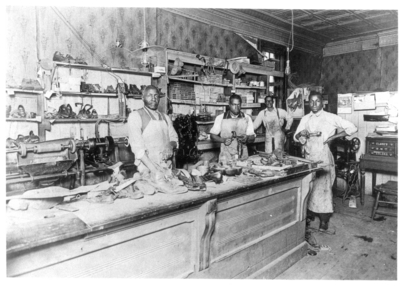Four men working in the shoe shop