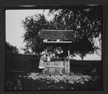 Girl standing at well