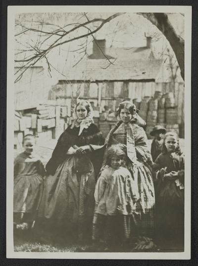 Woman standing with several children