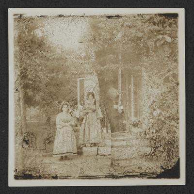 Two girls standing in garden