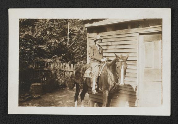 Female, unidentified, riding a horse. Similar image as item 219