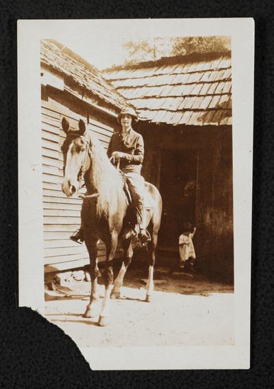 Female, unidentified, riding a horse. Similar image as item 218