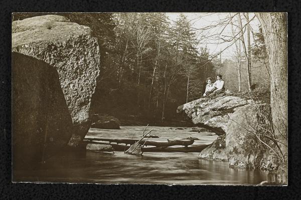 Females, unidentified, sitting on edge of the river at Big Sandy