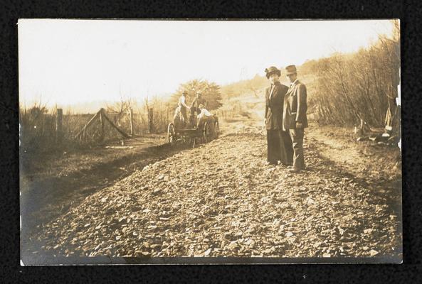 Cora Wilson Stewart and Marion Ross, back of the photograph reads: Picture of Marion Ross, Assistant in Department of Public Roads of Kentucky, and Mrs. Cora Wilson Stewart, Superintendent Rowan County Schools, on the model road in front of Alfrey School