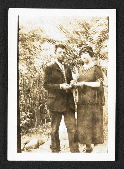 Cora Wilson Stewart and an unidentified male posing outside