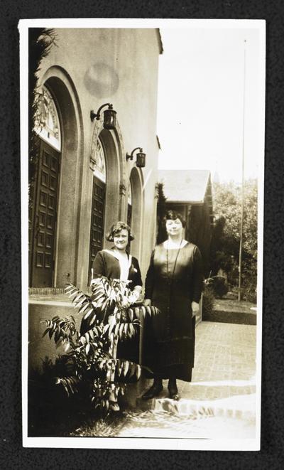 Cora Wilson Stewart and an unidentified female standing outside
