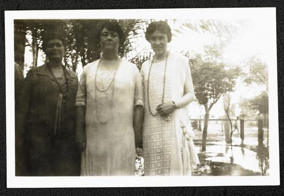 Cora Wilson Stewart and two unidentified females standing outside, all wearing long necklaces- the same outfits in item #50 and #52