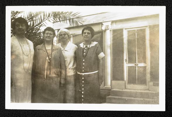 Cora Wilson Stewart and three unidentified females standing in front of the same building in item #50, wearing the same clothes in item #50 and #51