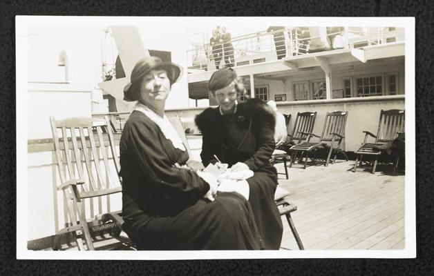 Cora Wilson Stewart and an unidentified woman sitting on the deck of a large passenger ship