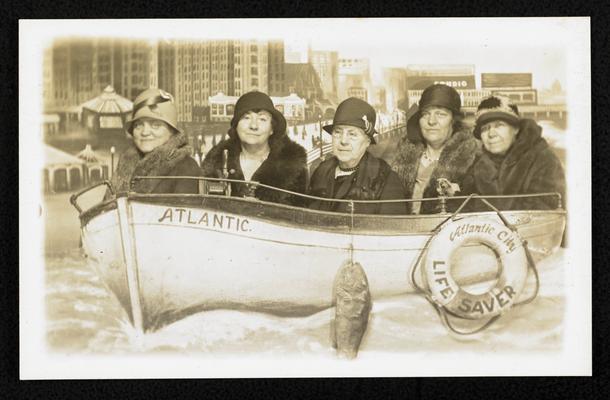 Cora Wilson Stewart and four unidentified women posing for a picture in a portrait stage set-up of a boat