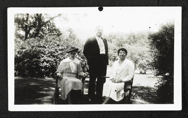 Cora Wilson Stewart posing with the same couple from item #56, Cora and the other female sitting in chairs outside, the male standing