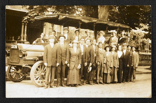 Cora Wilson Stewart and an unidentified group of men and women, posing in front of a bus. The hand-written note at the bottom of the photograph reads: Our trip to Niagara Falls