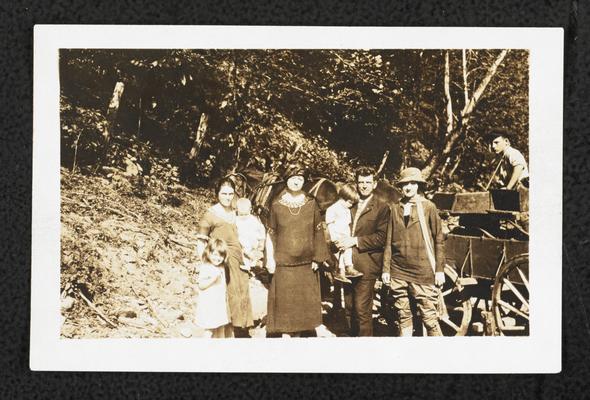 Cora Wilson Stewart posing with unidentified men, women, and children in front of a horse drawn carriage, taken the same day as item #217 and #256