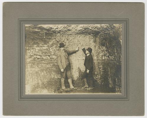 Two unidentified males looking at a coal seam. Back of the photograph reads: Elkhorn Company Coal Pike County