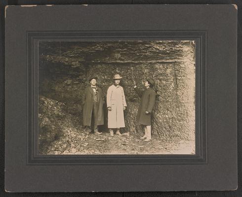 Three unidentified males, looking at a coal seam. Nack of the photograph reads: Coal Seam near Elkhorn. Elkhorn County, Coal 7 ft. thick