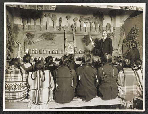 Unidentified group attending a lecture given by an unidentified white man