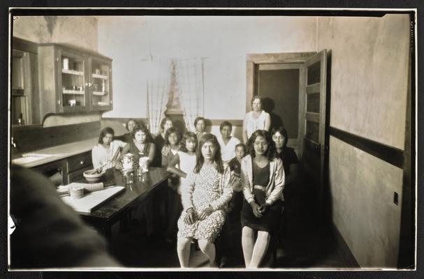 Arizona students. Female hispanic students sitting in a kitchen