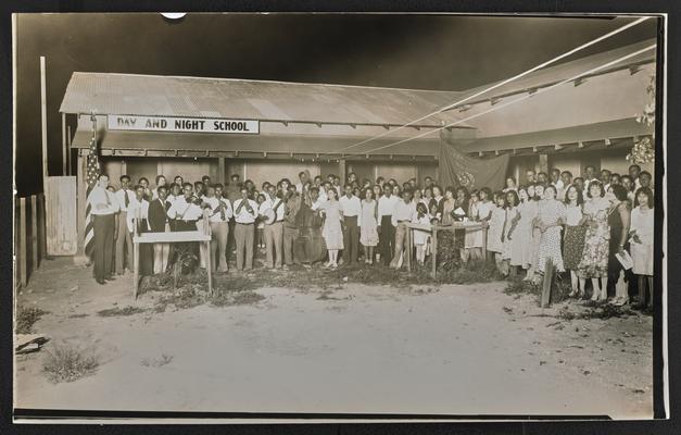 Arizona students. A large group of Hispanic students standing in front of building that reads Day and Night School