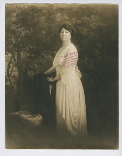 Portrait proof of Cora Wilson Stewart, standing at a chair and facing left