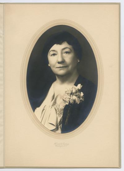 Portrait of Cora Wilson Stewart as an older woman, wearing a boutineer. Portrait was taken at Harris & Ewing studio in Washington D.C