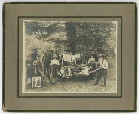 Unidentified male students, building picture frames outdoors