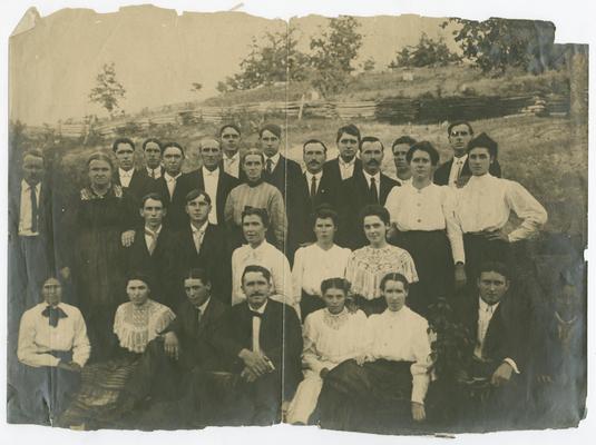 Unidentified adult students posing for the photograph outside