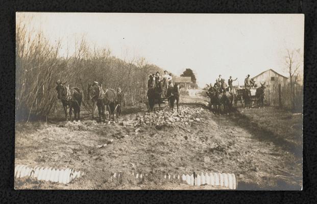 Men with horses, working on the model road in front of Alfrey School in Rowan County