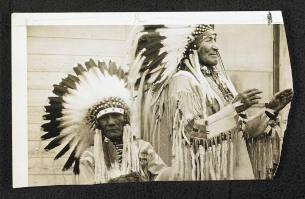2 unidentied males wearing traditional Native American costumes