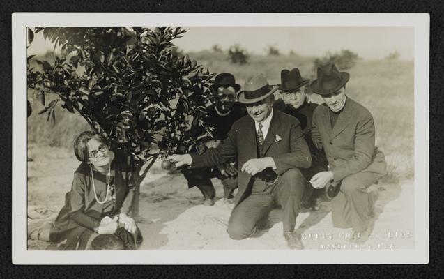 Mrs. Pendleton, back of the photograph reads: Picking the first orange I saw on my grove, Nov. 19-1926. The trees were planeted 3 years ago, January 1924