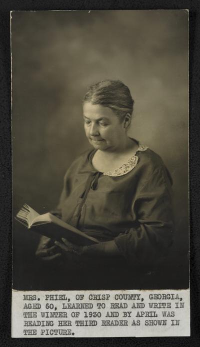 Mrs. Phiel, of Crisp County, Georgia, aged 60, learned to read and write in the winter of 1930 and by April was reading her third reader as shown in the picture