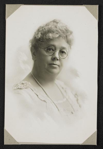 Female, unidentified. Formal portrait taken at The Bell Studio in Newton, IA or Grinnell, IA