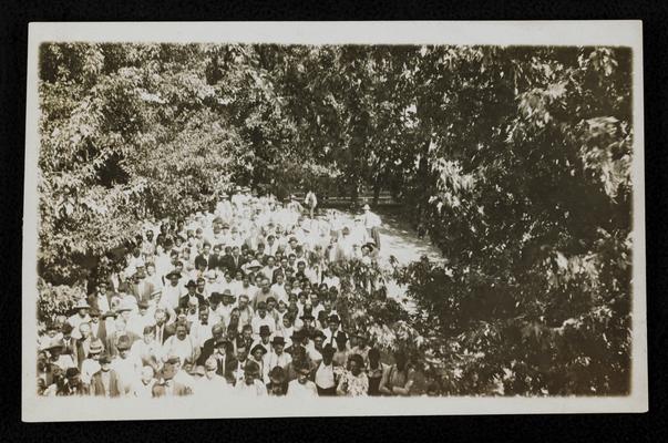 Group, undentified, crowded together outside