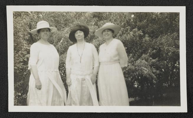 Cora Wilson Stewart and two unidentified females, standing outside and all wearing white dresses and hats