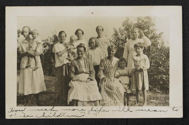 Kentucky students. Hand written notes on the photograph reads: How much more life will mean to these children. Ladies (illiterate) learning to read and write in the Geneva's Adult School. Six or seven are ladies who are members of the intermediate grade