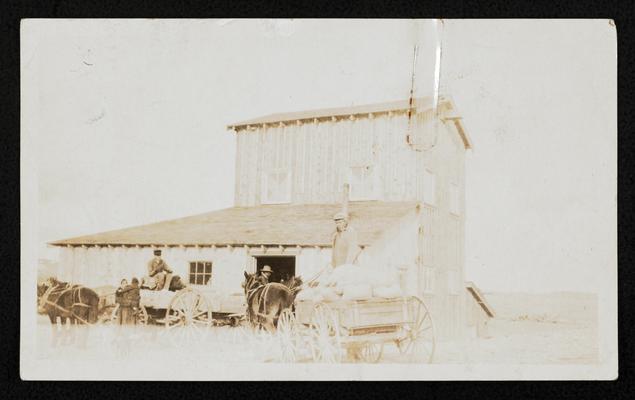 Note attached to the photograph reads:  Big Lodge Pole bringing his wheat to the mill 2nd year of the program. Big Lodge Pole is 70 years of age and is a strong supporter of the program and is President of the Chief All over Chapter. Thought you might use this in the lesson the mill