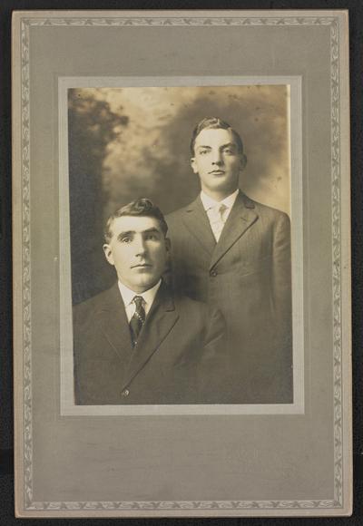 Males, unidentified, formal portrait with one sitting and one standing