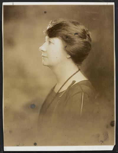 Formal portrait of Cora Wilson Stewart, facing left in profile. Back of the photograph reads: harper Standard Engraving Co. Artists and Engravers-- Dallas, Tex