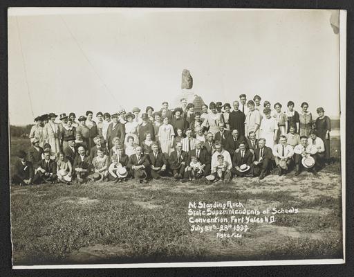 A large group photograph, Cora Wilson Stewart standing center. The bottom of the photograph reads: At Standing Rock, State Superintendents of Schools, Convention Fort Yates, North Dakota, July 24th-28th, 1922