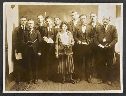 South Carolina students. Back of the photograph reads: Night Class of South Carolina students, all of whom were illiterate three years before picture was made. The woman in the foreground is the teacher