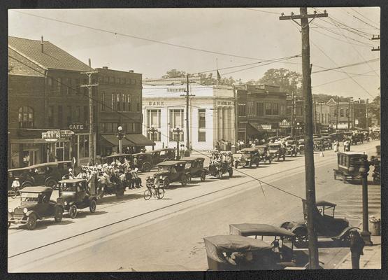 A small part of the parade, Tuscaloosa County, Alabama. Adult Day-1923. Some fifteen trucks and 40 or 50 cars