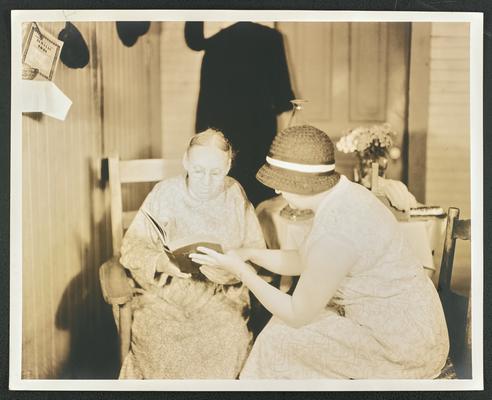 Female, unidentified. Same woman from item #231, this time being taught to read by another woman
